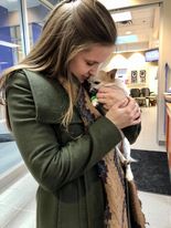 Vet student holding dog 